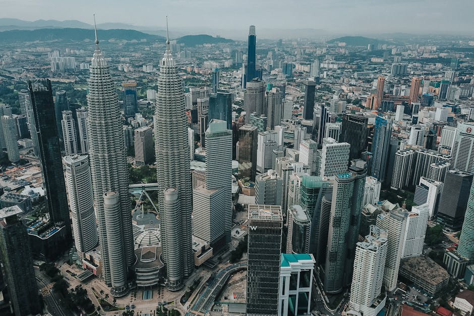 Breathtaking aerial view of Kuala Lumpur's skyline featuring the iconic Petronas Towers.